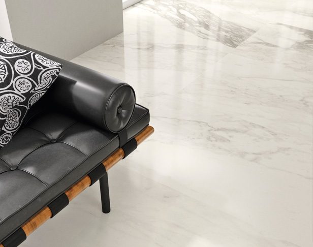 White marble look tiled floor with black vinyl sitting chair and black and white pillow