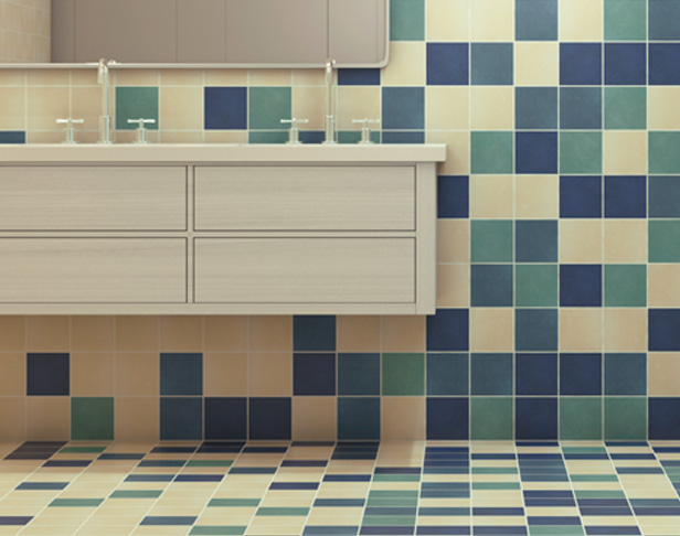 Different shades of blue square tiles on a public bathroom wall and floor