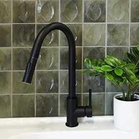 Ozean Giada Green tiled backsplash with modern black faucet