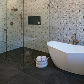 white and black striped hex tile, dark gray tiled bathroom floor