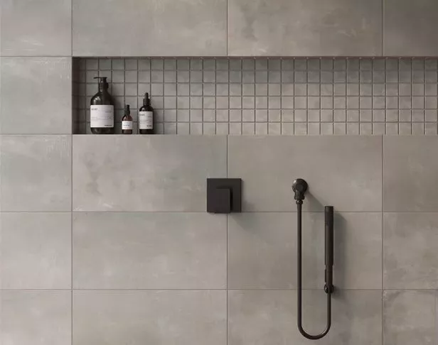 Gray concrete-look 12x24 tiles and matching mosaics tiled contemporary shower
