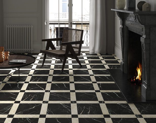 checkerboard and grid patterned black and white marble tile floor with a chair next to a fireplace