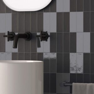 Black matte and glossy rectangular tiles with black wall mount faucet and free-standing white modern sink