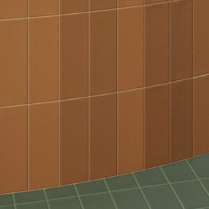 Terracotta colored matte and glossy rectangular tiled wall