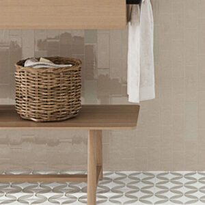 Beige rectangular tiled bathroom wall with wood bench, basket, and white towel