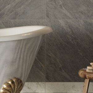 Gray marble tiled bathroom wall with white clawfoot tub and gold fixtures