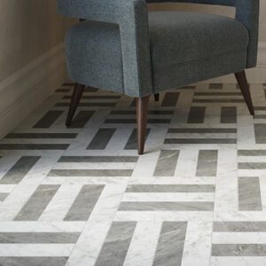 Gray and white 3x12 marble tiles in a hatch pattern with blue sitting chair