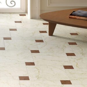 Ivory marble look tiles with small red marble tiles in a staggered pattern with a coffee table
