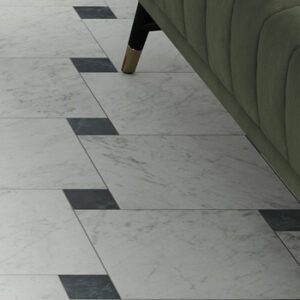 Square white marble tile with dark green smaller tiles in a dot pattern with green sofa