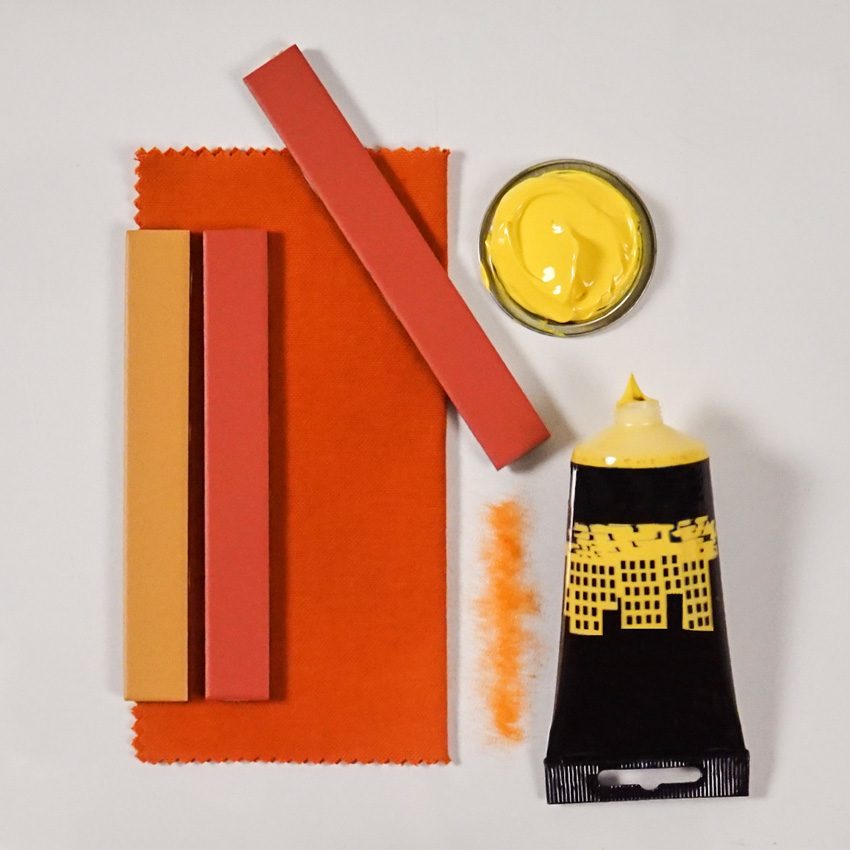 Skinny orange and yellow rectangular tiles with an orange fabric swatch and yellow paint tube