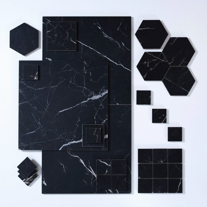 Black marble-look tiles in a variety of sizes laid out randomly
