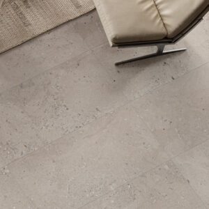light gray fossilized floor tile with light gray MCM chair and jute rug