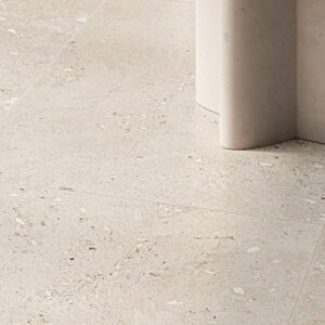 white fossilized floor tile showing detail with scultped accent table