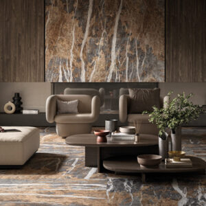 Gold, brown, and gray marble look large format tiled living space with beige sofa, chair, and brown coffee tables