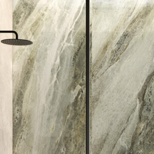 Large format green marble look tiled shower wall