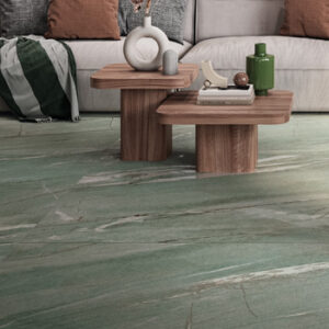 Large format pale green marble look tiled living space with beige sofa and two accent tables