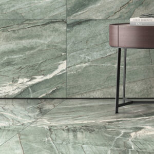 Large format pale green marble look tiled wall and floor with modern accent table