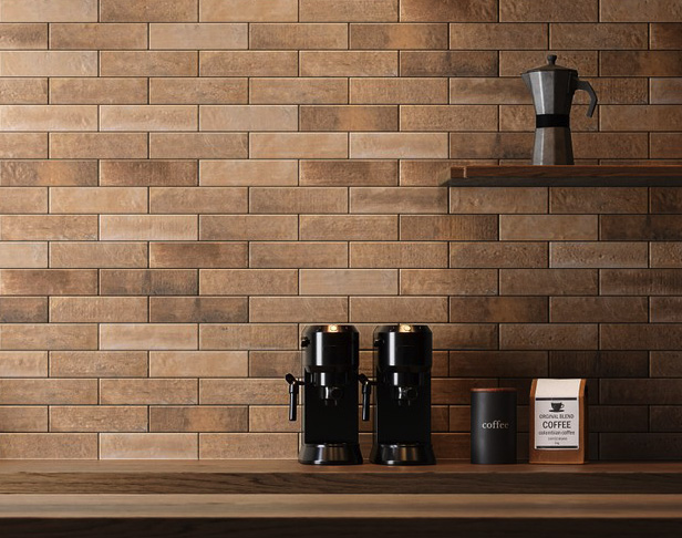 Golden brown subway tiled kitchen backsplash with countertop with coffee makers and bags of coffee