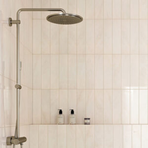 Beige marble look 4x16 glossy tiled shower