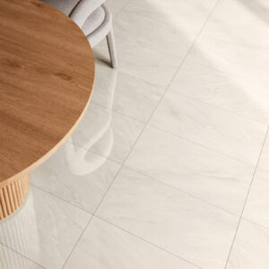 Beige Marble look tiled kitchen floor with round pine table