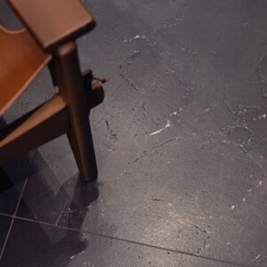 Black marble look tiled floor with MCM chair
