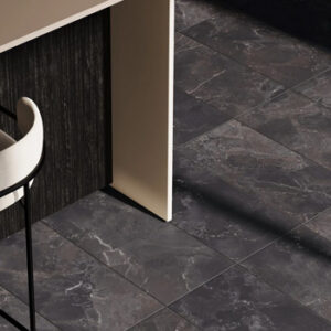 Black marble look tiled kitchen floor with waterfall island and modern white stool