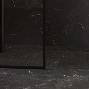 Black marble look mosaics on a shower floor with black trim glass