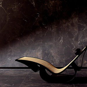 Black marble look tiled floor and wall with modern lounge chair