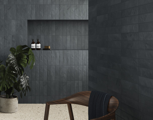 Very dark blue brick tiles on walls with cut-out shelving