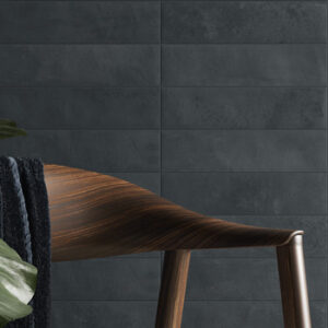 dark blue small formate tiled wall with dark wood chair