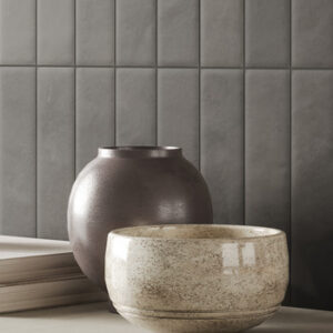 gray small format tiled wall with vase and bowl