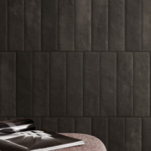 black small format tiled wall with accent table and magazine