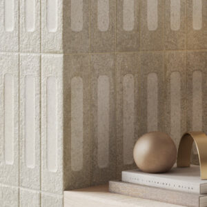 beige brick tiled wall with books and ball