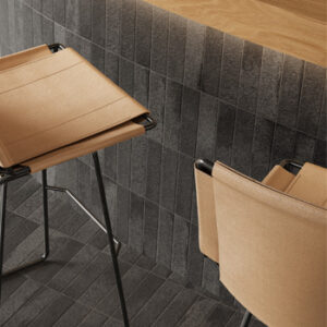black brick tiled kitchen counter and. floor with tan leather stools