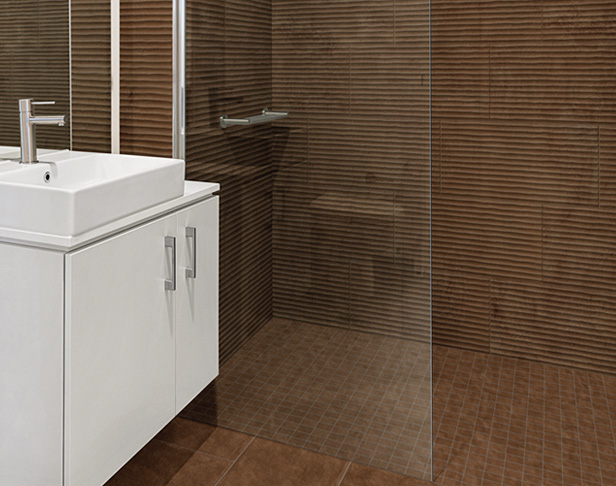 Fluted terracotta tiled shower with white floating vanity and silver faucet