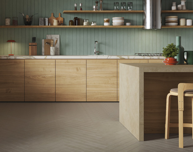 Pale green long, narrow tiled modern kitchen backsplash with gray long, narrow tiles in a herringbone pattern on the floor