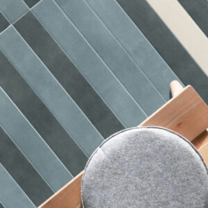 light and dark blue narrow tiles on a floor with bench and round cushion