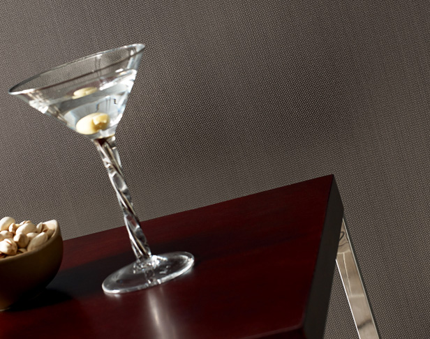 Brown porcelain tiled wall with martini on dark brown and chrome accent table