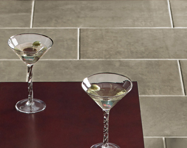gray porcelain tiled floor with martini on dark brown and chrome accent table