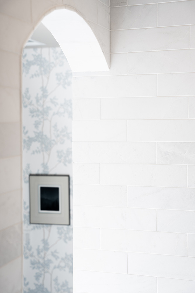 White marble tiled wall and archway