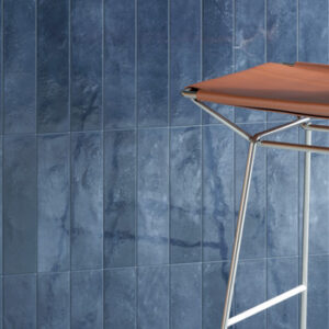 glossy blue small format tiled wall with leather and chrome chair