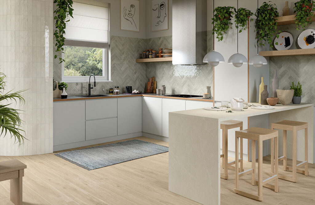 gray glossy small format tiled kitchen backsplash in a herringbone pattern