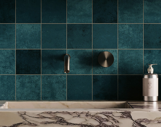 Dark teal high gloss 4x4 tiled bathroom wall with wall-mount faucet and rectangular carrara marble sink