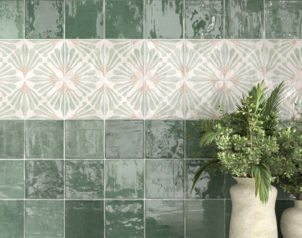 Green glossy 4x4 tiled backsplash with floral decorative accent tiles