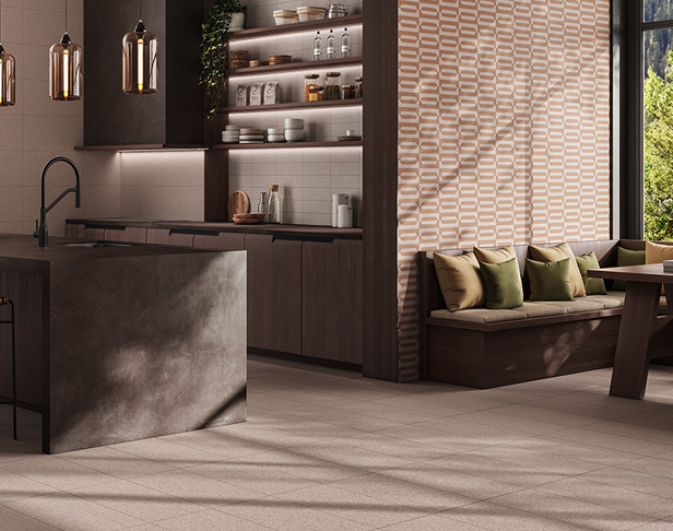 Beige and tan fabric-look tiled kitchen floor with two-tone geometric accent tiles on wall with kitchen island with sink, brown cabinets, floating shelves, and eating nook with large window