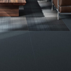 Blue porcelain tiled living space floor with dark rustic coffee table and metal legged chair