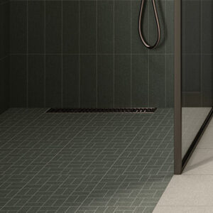 green fabric look basketweave mosaic installed on a shower floor