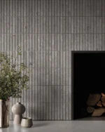 This chic fireplace 🔥  showcases the Dolomia Collection in Ash color 6” mosaic, creating a sleek, contemporary focal point with a subtle textured pattern. The 1” mosaic stick tiles bring a minimalist yet bold aesthetic, perfect for a modern interior with timeless elegance.