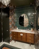 This moody yet glamorous powder room is a modern take on Art Deco.
The floor features Garden State Tile’s Bianco Carrara for a timeless touch, while the scalloped shower floor adds a subtle yet stunning detail.🤩 designed by @bloom_street_
